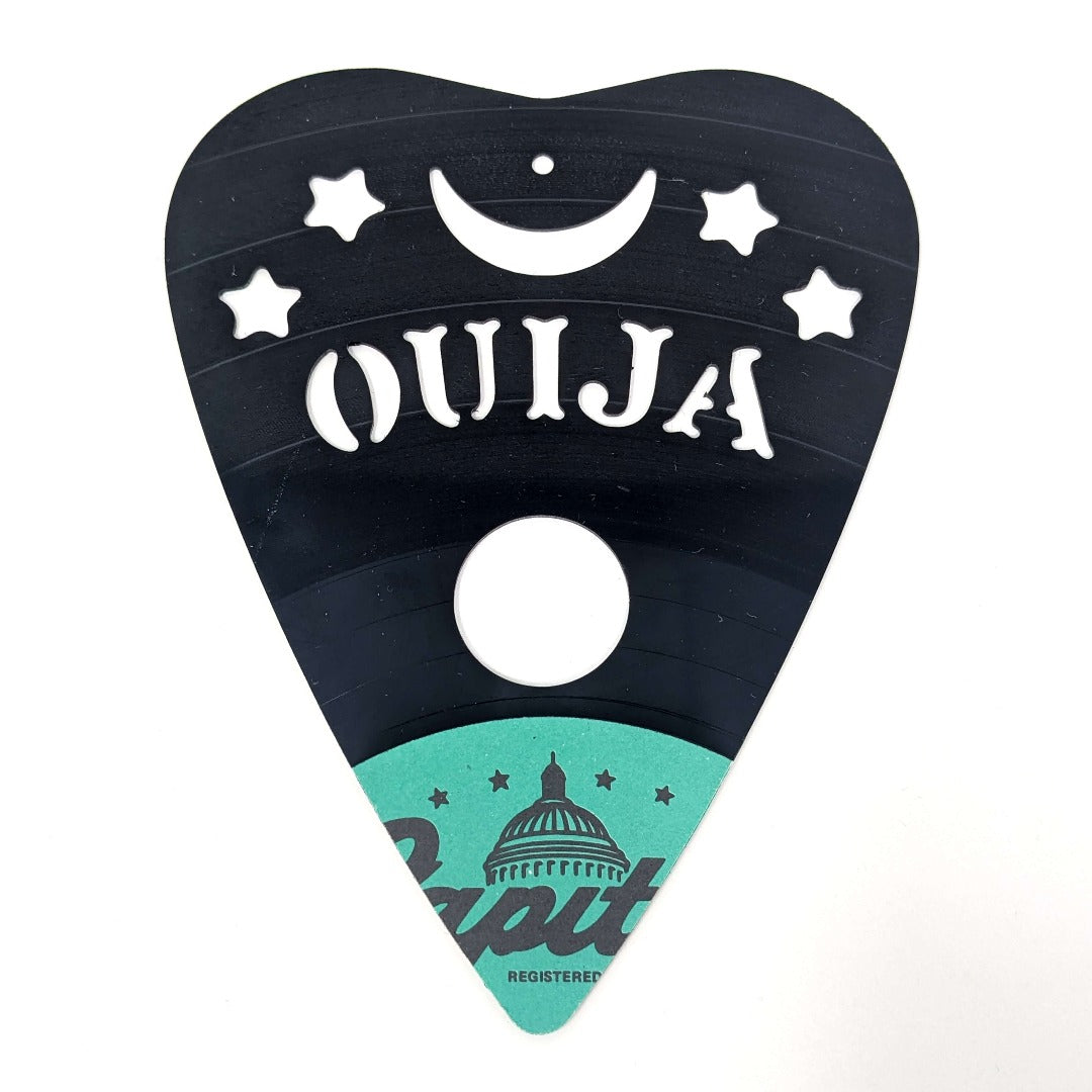 Upcycled vinyl record Ouija table with intricate CNC design.