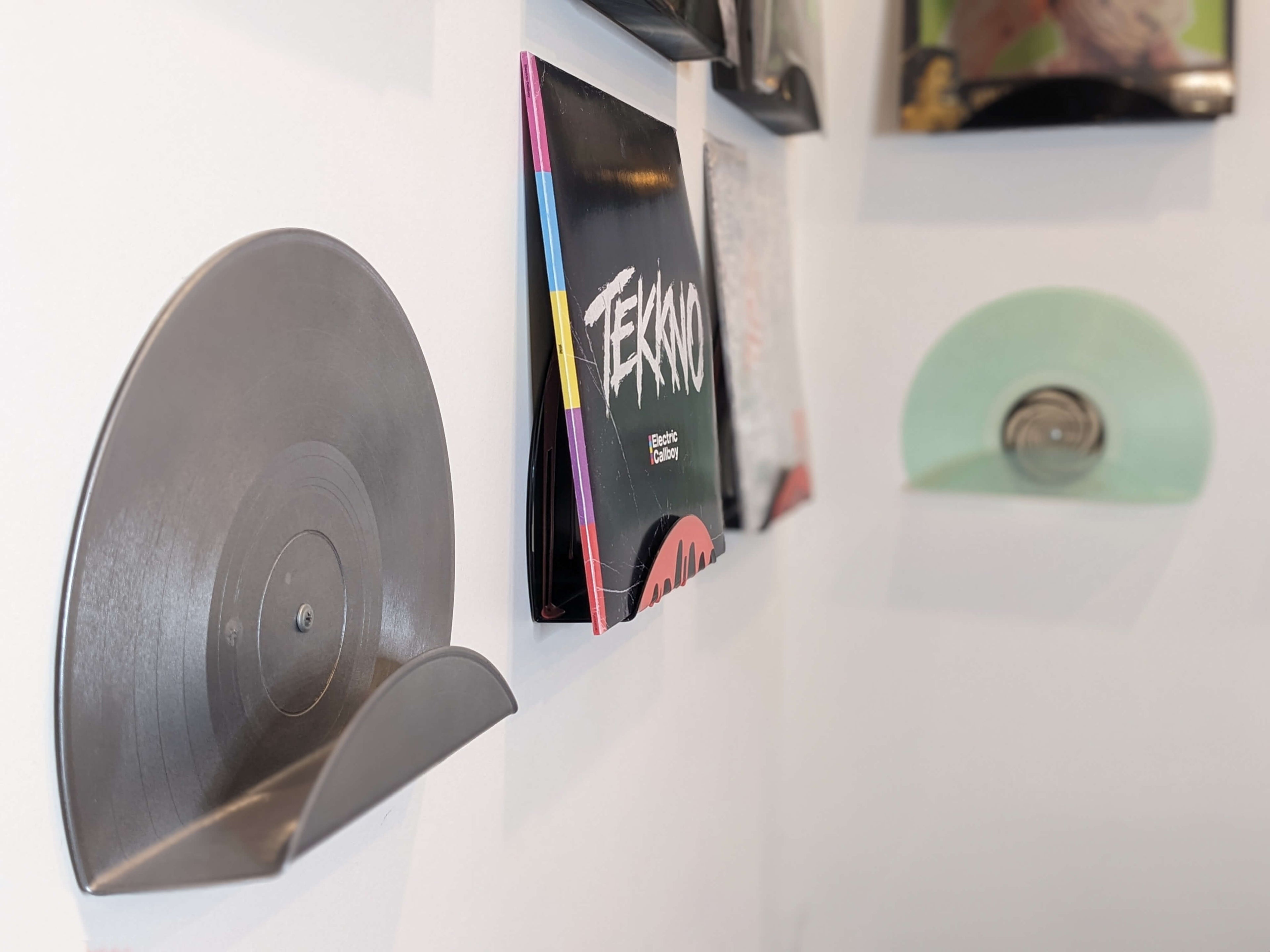 Upcycled vinyl record displays showcasing Tekkno by Electric Callboy and Sum 41 in 514 RPM store's living room