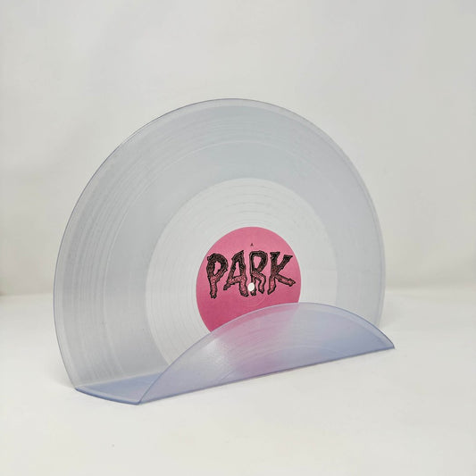 A clear vintage record used as a wall decor shelf
