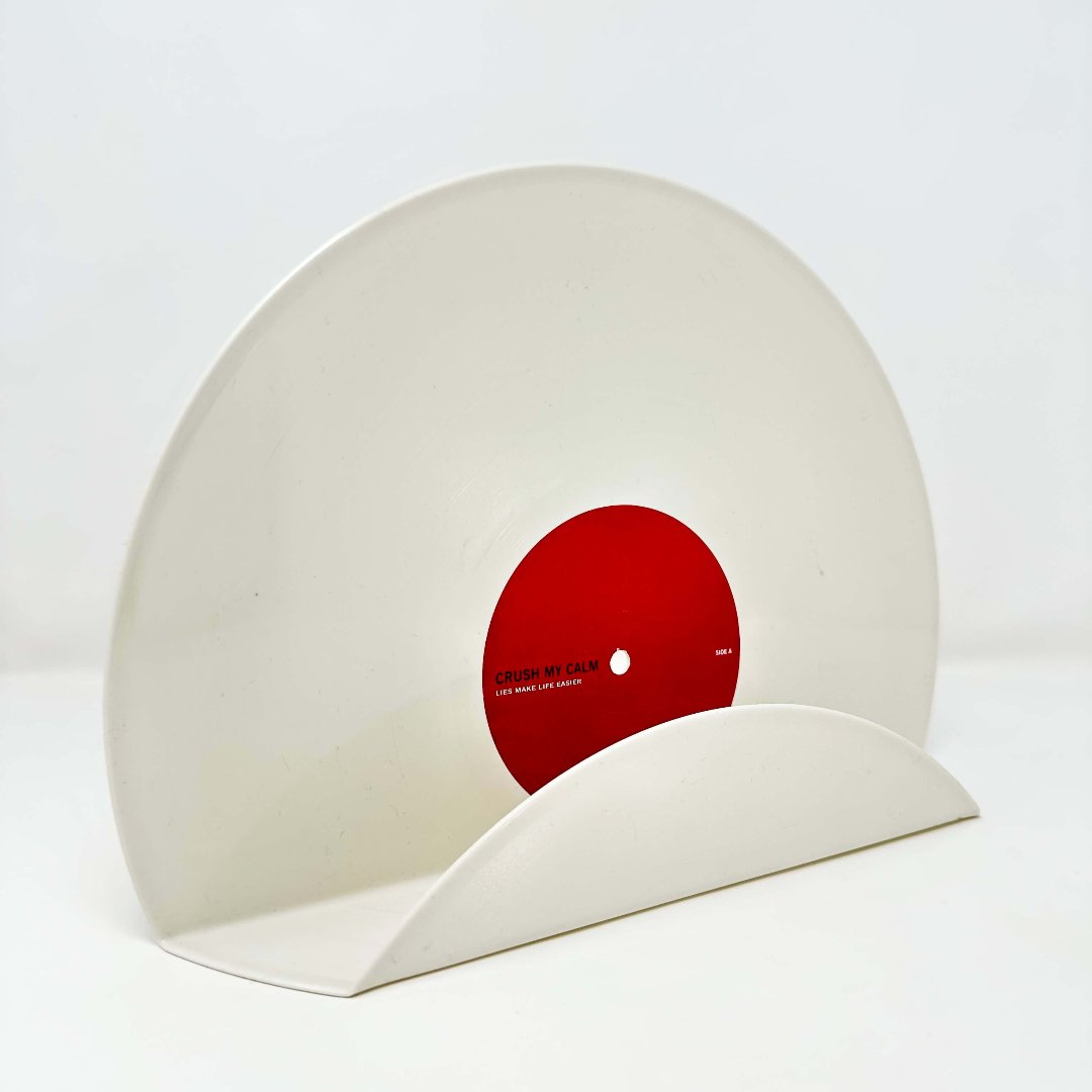 A retro-style white vinyl record used as a wall decor shelf