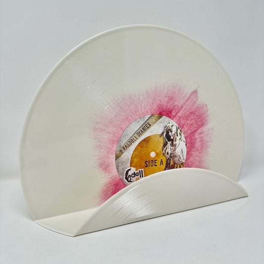 A modern pink and white vintage vinyl record used as a decor shelf