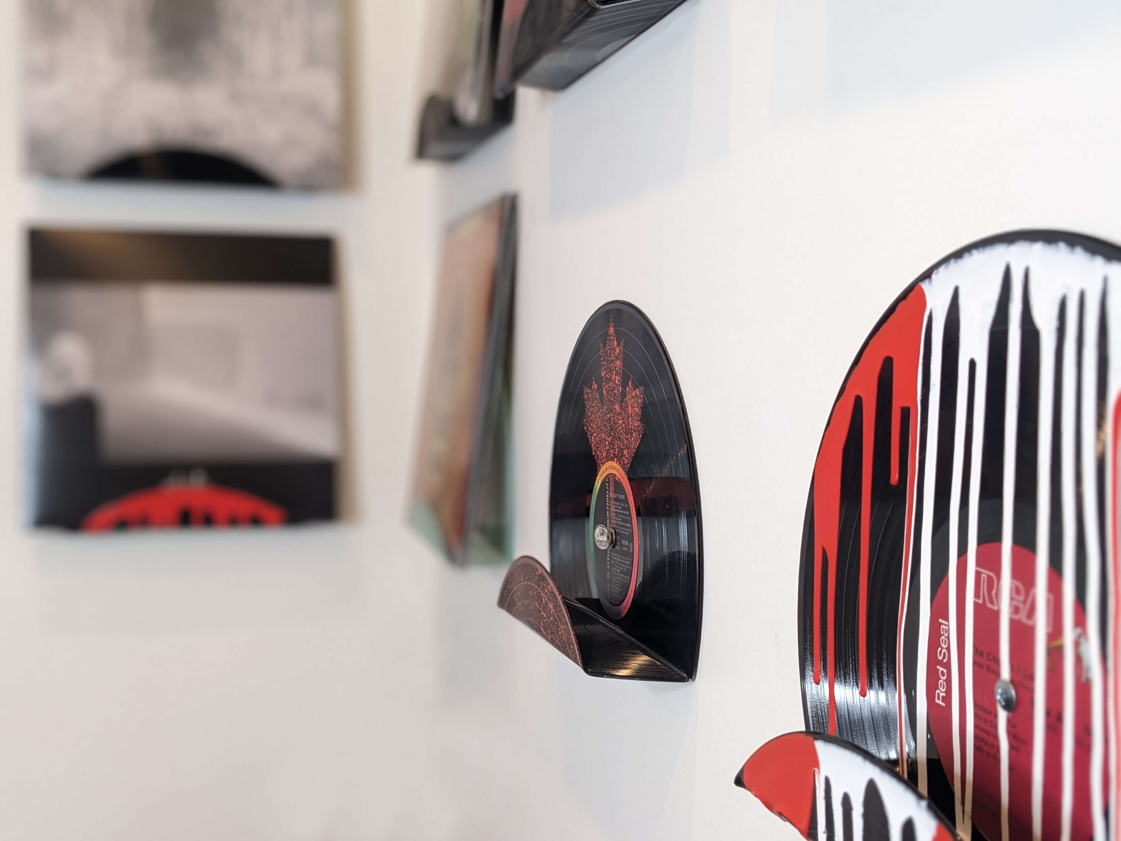 Upcycled vinyl record displays featuring Solstafir and Sum 41 with a maple leaf in 514 RPM store's living room