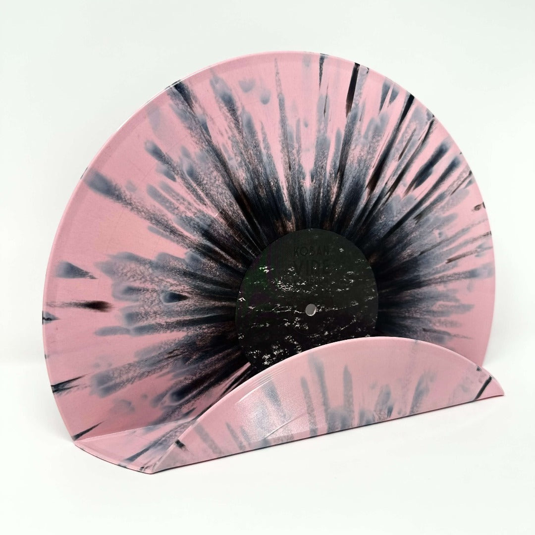 A stylish pink splatter vintage vinyl record used as a wall decor shelf