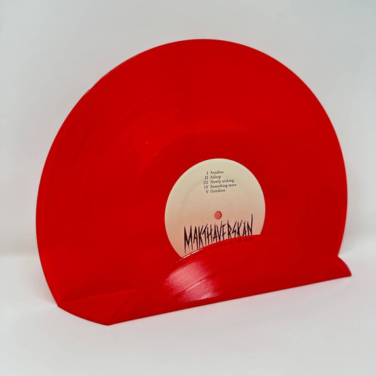 A vintage red record used as a wall decor shelf